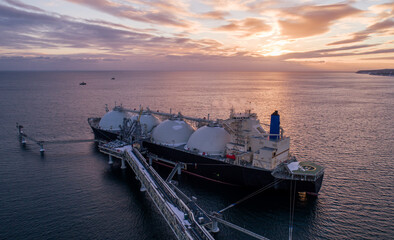 aerial of liquified natural gas lng carrier moored to a small gas terminal. fuel crisis. sanctions