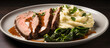 Sliced steak with mashed potatoes and spinach on a plate