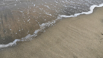 Wall Mural -  Transparent sea wave on the sand natural background