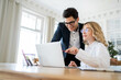 © muse studio - Two people use a laptop computer working in the office colleagues in the company, business entrepreneurs online business.