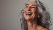 Beautiful gorgeous  mid age beautiful elderly senior model woman with grey hair laughing and smiling. Mature old lady close up portrait. Healthy face skin care beauty, skincare cosmetics, dental. 