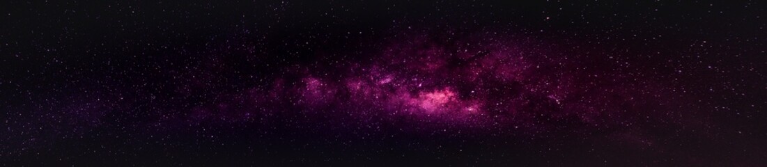 Wall Mural - milky way in the night sky and stars on dark background with noise and grain. photo taken with long 