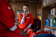 rescue nurse holds a walkie-talkie wearing a uniform and rushes to help a patient who has been in an accident. The team helps CPR the injured person and uses a life support machine in the ambulance.