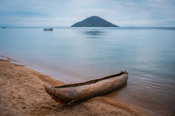 a dugout canoe on the shore of lake malawi in cape maclear, malawi