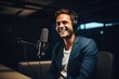 © Vorda Berge - Smiling young man talking on podcast in studio