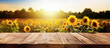 Empty rustic old wooden boards table copy space with sunflower field background, afternoon sun above. Product display template. Generative AI