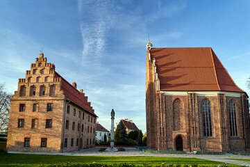 Poster - Gothic, Catholic church and a historic brick tenement house in Poznan