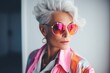 © GoldenART - stylish senior woman in sunglasses and pink scarf looking away at home