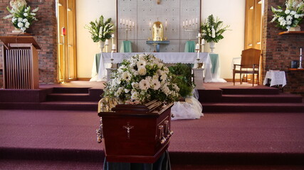 closeup shot of a funeral casket or coffin in a hearse or chapel or burial at cemetery
