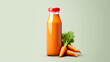 Carrot juice in a bottle on a colored background.