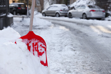 Wall Mural - Shovel in snowdrift on city street. Space for text