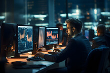 Businessman Working On Multiple Computer Monitors In Office At Night. Stock Market Trading Concept