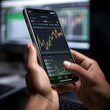 © Lori - Person analyzing stocks on their phone. Stock charts are visible on the phone and in the background - Generative AI