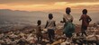 Children playing on hillside overlooking town at dusk. Childhood and resilience.