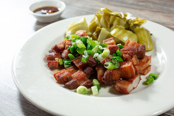 A view of a plate of deep fried pork belly.