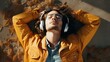 © Kowit - Close-up portrait of young smiling man enjoying and dreaming with headphones, listen the music, upper view
