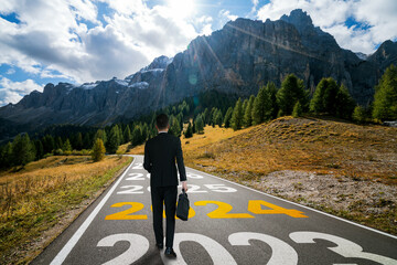 Wall Mural - 2024 New Year journey and future vision concept . Businessman traveling on highway road leading forward to happy new year celebration in beginning of 2024 for bliss and successful start .