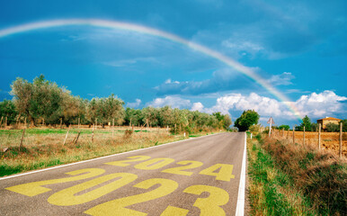 Wall Mural - 2024 New Year road trip travel and future vision concept . Nature landscape with highway road leading forward to happy new year celebration in the beginning of 2024 for bliss and successful start .