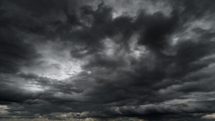 dark dramatic sky with black stormy clouds before rain or snow as abstract background, extreme weath