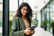 © PRASANNAPIX - Young businesswoman using smartphone