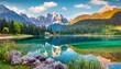 colorful summer view of fusine lake bright morning scene of julian alps with mangart peak on background province of udine italy europe