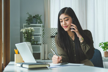 Beautiful businesswoman having a pleasant conversation on mobile phone.