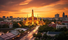 Grand Palace And Wat Phra Kaew Glowing In The Asian Sunset - A Landmark In Bangkok, Thailand.