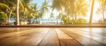 Wooden Terrace Blur Tropical Beach With Bokeh Sunlight Waves And Palm Trees In Coffee Photo Room Space