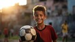 © Bilal - Portrait of a boy holding a soccer ball and smiling at the camera