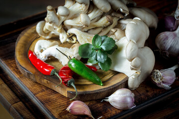 Champignon mushrooms in composition with food ingredients on old background