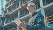 © Alena - Construction inspection. Elderly man with a gray beard and a helmet holding a tablet against the background of house construction.