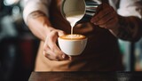 Fototapeta Las - Barista pouring milk to create latte art for coffeehouse marketing