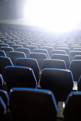 Wall Mural - empty theater seats with bright wight light coming from stage