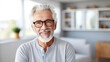 Warm and welcoming elderly man with silver hair and glasses, smiling confidently in bright, modern kitchen, hinting at refined taste for interior design with friendly demeanor. Banner with copy space