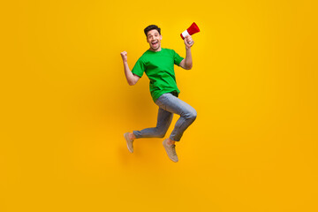 Poster - Full length photo of satisfied ecstatic man jumping holding loudspeaker shout yeah win lottery isolated on yellow color background