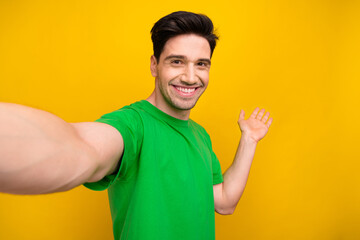 Poster - Photo portrait of nice young brunet male selfie palm point empty space dressed stylish green garment isolated on yellow color background