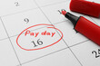 © New Africa - Red felt pen on calendar page with marked payday date, closeup