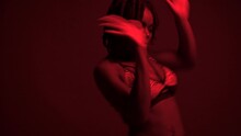 Studio Shot Of Black Woman Dancing Dancehall Under Neon Lights
