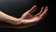 © NizuCaCi - Hand receiving something, left hand, male, close-up, black background