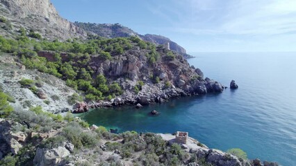 Wall Mural - Cliffs on the Mediterranean coast. Aerial view of medieval watchtower next to the cliffs. Mediterranean coast landascape. Andalusia. Spain.