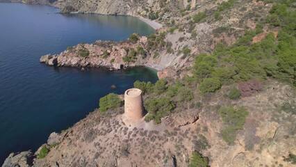 Wall Mural - Aerial view of medieval ruins next to the cliffs. Medieval watchtower over the cliffs on the Mediterranean coast. Andalusia. Spain.