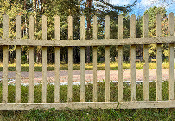 Sticker - Yellow wooden fence in nature. Background