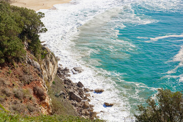 Wall Mural - a view from the top of a steep hill over a body of water