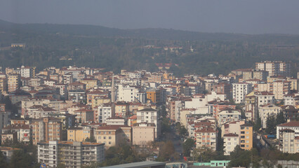 The view from the skyscraper window to the Asian part of Istanbul. City development. On the horizon of mountains and hills.