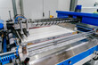 Conveyor production of large sheets of cut glass. Cutting, washing, framing, tempering of glass by machine on a conveyor line. Without human intervention. View in the vicinity of the equipment