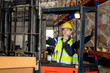 © Hip.hub - Focused driver operating forklift machine in warehouse