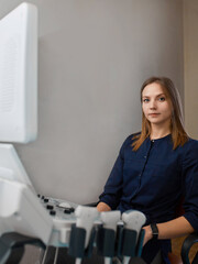 Wall Mural - Portrait doctor doing ultrasound examinationof patient in clinic