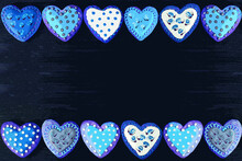 Illustration Of Frame Of Beautiful Patterned Heart Shaped Royal Icing Cookies On Black Background