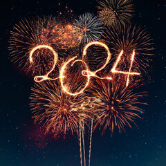 Happy New Year 2024. Festive golden fireworks explode in the starry sky