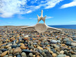 Beach with pebbles and a whale vertebrain in Patagonia, Tierra del Fuego, Argentina in spring.